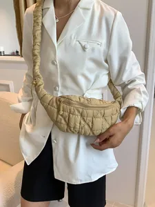 Stylish khaki quilted cloud crossbody bag featuring an adjustable drawstring strap.
