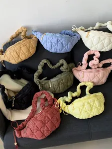 Assorted vibrant quilted cloud chest bags arranged on a sofa for a stylish look