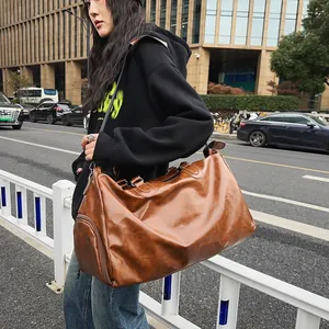 Vintage brown PU leather travel bag with shoe compartment shown on street