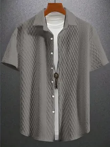 Detailed macro view of men's grey short-sleeve knit shirt featuring diamond jacquard texture