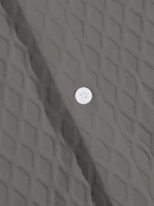 Close-up of the grey knitted jacquard shirt fabric featuring a white button detail