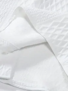 Premium white short-sleeved knitted shirt with intricate jacquard textured patterns