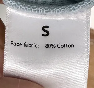 Detailed view of the S size care label showing cotton and polyester fabric blend
