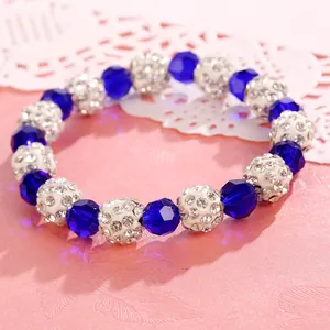 Macro view of blue crystal and rhinestone encrusted beads on a sweet Korean bracelet