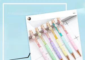 Detailed view of six colorful crystal ballpoint pens with four-leaf clover clips.