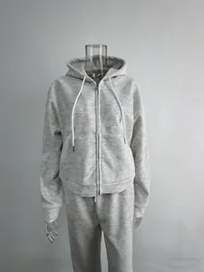Detail of a grey heathered zip-up hoodie and matching sweatpants loungewear set.
