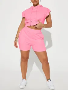 Bright pink women's two-piece sports set with hooded short-sleeve top and matching shorts.