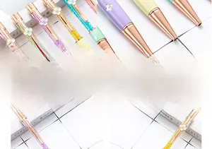 Detail shot of elegant sparkling clover crystal ballpoint pens in rose gold finish