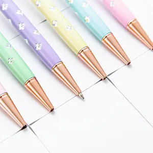 Elegant pastel ballpoint pens with rose gold tips and sparkling clover crystal accents