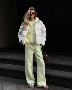 Detailed view of women's casual hooded zip-up sweatshirt and sweatpants set in yellow