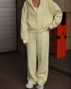 Full view of pale yellow zip-up hooded sweatshirt and loose matching sweatpants set