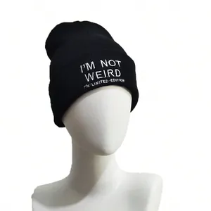 Black Y2K gothic knitted beanie with 'I'M NOT WEIRD' embroidery on white mannequin