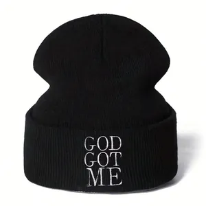 Black Y2K knit beanie featuring white GOD GOT ME gothic embroidery for men and women.