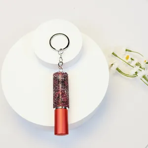 Close-up of a 5ml portable rhinestone-encrusted perfume atomizer keychain in red