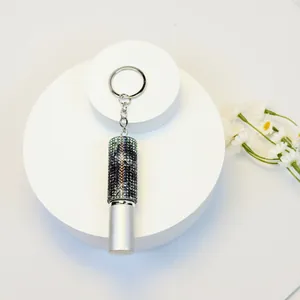 Detail of a 5ml mini rhinestone-encrusted perfume bottle keychain with a silver finish.