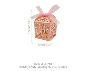 Close-up view of pink hollow-out paper candy box with elegant cross and flower patterns