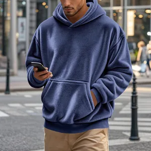 Gros plan sur la texture douce en polaire bleue d'un sweat à capuche décontracté pour hommes.