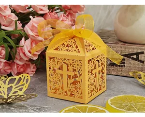 Detailed view of yellow laser-cut candy box with cross and flower patterns