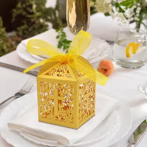 Yellow laser-cut favor box with cross and flower patterns for wedding or baptism events
