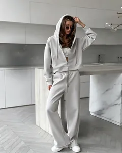 Casual women's zip-up hooded sweatshirt and wide-leg jogger pants set in light gray
