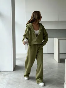 Full view of women's olive green zip-up hoodie and wide-leg sweatpants set on model.