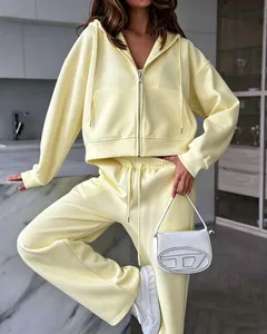 Stylish pale yellow two-piece tracksuit set featuring a zip-up hoodie and joggers