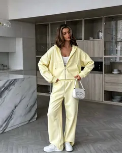Stylish pale yellow women's oversized zip-up hoodie and wide-leg sweatpants two-piece set