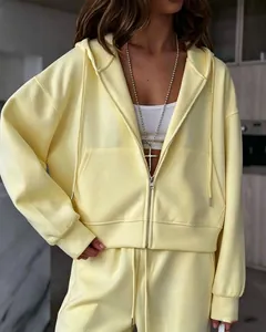 Detailed view of trendy light yellow oversized zip-up hoodie and sweatpants set for women