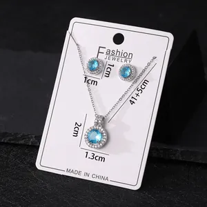 Detailed view of silver-toned blue zircon necklace and earring set with measurements