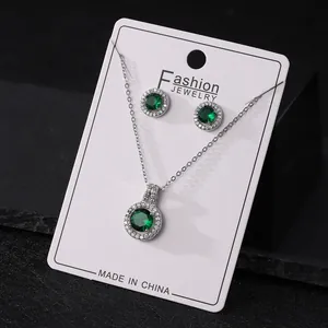 Elegant green round zirconia necklace and earrings jewelry set on a white display card