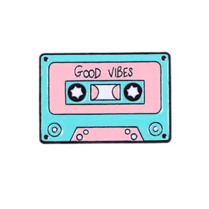 Retro style turquoise and pink cassette tape enamel pin with GOOD VIBES text engraving