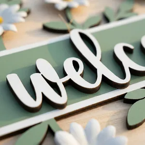 Detailed close-up of a wooden welcome hanging sign with decorative floral patterns