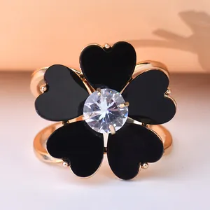 Detailed macro view of a rose flower scarf ring with black heart petals and center gem