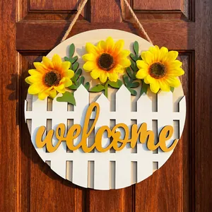 Decorative wooden welcome sign featuring artificial sunflowers and picket fence for home