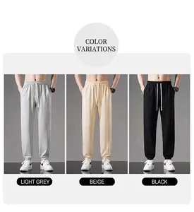 Detailed display of men's breathable cotton jogger pants in grey, beige, and black