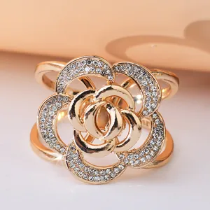 Close-up of elegant gold rose scarf ring with sparkling rhinestone details