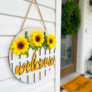 Round wooden welcome sign with sunflowers and white fence detail for home front door