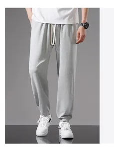 Full length view of men's loose gray cotton joggers with drawstring and elastic cuffs