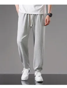 Full length view of men's loose gray cotton joggers with drawstring and elastic cuffs