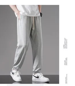 Full side view of stylish men's grey lightweight cotton joggers with comfy elastic cuffs