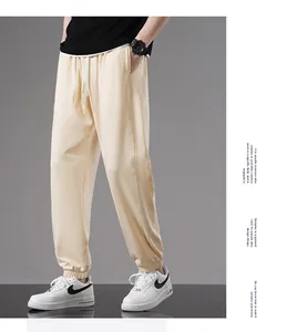 Comfortable men's cream cotton jogger sweatpants with elastic waist and drawstring detail.