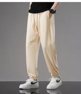 Comfortable men's cream cotton jogger sweatpants with elastic waist and drawstring detail.