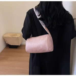 Back view detail of a pink leather pillow bag with stylish wide geometric strap