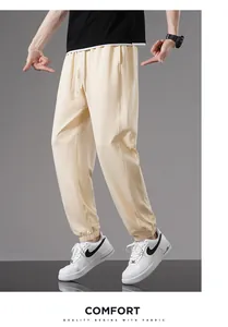 Detailed look at stylish men's loose beige cotton jogger pants for summer wear