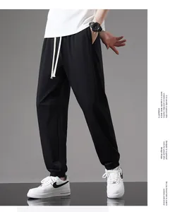 Full length view of men's black lightweight cotton joggers with relaxed fit and cuffs