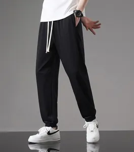 Full length view of men's black lightweight cotton joggers with relaxed fit and cuffs