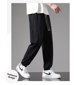 Detail view of men's lightweight black cotton joggers featuring a stylish drawstring waist