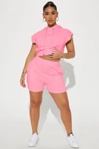 Detail view of pink sleeveless hoodie and matching shorts set worn by female model