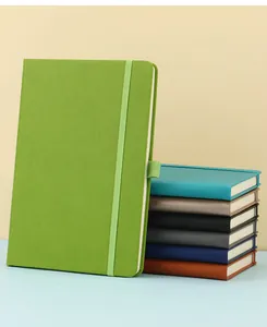 Macro detail of various A5 elastic band notebooks in vibrant colors for office use.