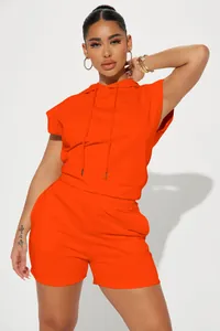 Vibrant orange two-piece sleeveless hoodie and shorts set for trendy street style